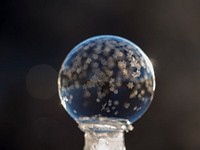 Macro of a frozen bubble with small snowflakes with a black background. Original public domain image from <a href="https://commons.wikimedia.org/wiki/File:Tiny_frozen_bubble_snowflakes_(Unsplash).jpg" target="_blank" rel="noopener noreferrer nofollow">Wikimedia Commons</a>