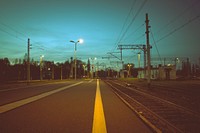 A view from the side of the street near a railway platform. Original public domain image from <a href="https://commons.wikimedia.org/wiki/File:Outside_near_railway_station_(Unsplash).jpg" target="_blank" rel="noopener noreferrer nofollow">Wikimedia Commons</a>