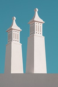 White concrete spires against a blue sky. Original public domain image from Wikimedia Commons