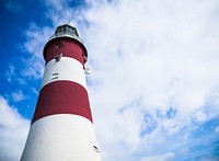 A lighthouse painted in red and white stripes. Original public domain image from Wikimedia Commons