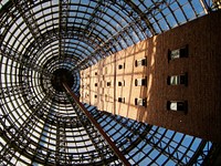 Upward perspective of a steel wire structure and building.. Original public domain image from Wikimedia Commons