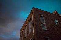 Moody exterior of an apartment building. Original public domain image from <a href="https://commons.wikimedia.org/wiki/File:Liam_2017_(Unsplash).jpg" target="_blank">Wikimedia Commons</a>
