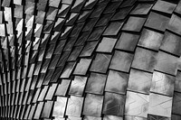 Black and white shot of undulating patterned architecture with reflection, Metropolitan City of Milan. Original public domain image from Wikimedia Commons