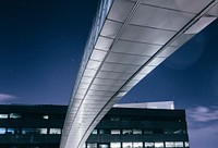 Skyway connecting to an office building at night. Original public domain image from <a href="https://commons.wikimedia.org/wiki/File:Office_bridge_(Unsplash).jpg" target="_blank" rel="noopener noreferrer nofollow">Wikimedia Commons</a>