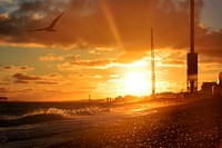 sunlight from sunset carves out silhouette of beach in Brighton construction site. Original public domain image from Wikimedia Commons