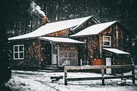 A cabin in the woods during the winter with snow over the roof. Original public domain image from <a href="https://commons.wikimedia.org/wiki/File:Classic_winter_cabin_(Unsplash).jpg" target="_blank" rel="noopener noreferrer nofollow">Wikimedia Commons</a>
