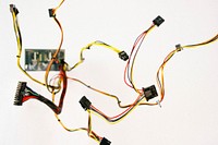 A micropchip with red, yellow, and orange PCI-E cords bursting from it over a white background. Original public domain image from Wikimedia Commons