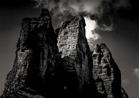 Eerie rock formations against a stormy dark sky. Original public domain image from <a href="https://commons.wikimedia.org/wiki/File:Rocky_peak_and_cloud_(Unsplash).jpg" target="_blank" rel="noopener noreferrer nofollow">Wikimedia Commons</a>