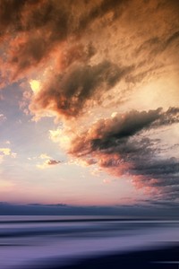 A beautifully colored sky and clouds over the water during sunset or sunrise. Original public domain image from Wikimedia Commons