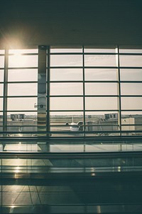 Shot of plane and sun at daytime from airport terminal window. Original public domain image from <a href="https://commons.wikimedia.org/wiki/File:Airport_terminal_window_sun_(Unsplash).jpg" target="_blank" rel="noopener noreferrer nofollow">Wikimedia Commons</a>