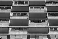 Black and white shot of urban building with balconies and windows. Original public domain image from <a href="https://commons.wikimedia.org/wiki/File:Monochrome_urban_balconies_(Unsplash).jpg" target="_blank" rel="noopener noreferrer nofollow">Wikimedia Commons</a>