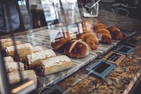 Freshly baked bread and pastries in the window of a bakery. Original public domain image from <a href="https://commons.wikimedia.org/wiki/File:The_Bakery_(Unsplash).jpg" target="_blank" rel="noopener noreferrer nofollow">Wikimedia Commons</a>