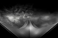 Unique curved architecture against a stormy sky. Original public domain image from Wikimedia Commons