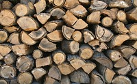 Logs for use as firewood, stacked to dry. Original public domain image from Wikimedia Commons