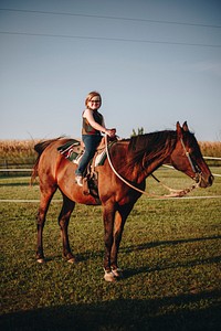 Young girl is enjoying a horse riding