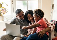 Happy black family and toddler pointing at a laptop screen