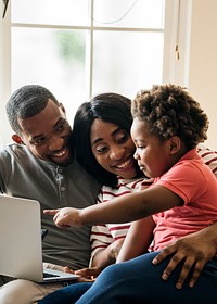 Happy black family and toddler pointing at a laptop screen