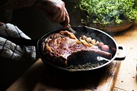 Chef cooking a steak in a pan food photography recipe idea