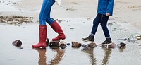 People walking on stones at the beach