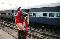 Photographer taking photos at a railway station in Varanasi