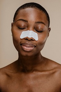 Black woman with a nose pore strip