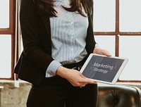 Businesswoman discussing marketing strategy with a tablet mockup