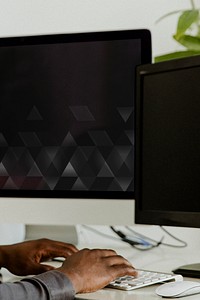 Black businessman working on a blank computer screen