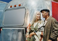 Cool senior couple standing by the food truck