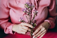 Woman in pink holding waxflowers