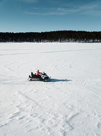 Man riding on a motor sled on a snowy day