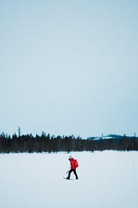 Woman with a backpack trekking in snowshoes