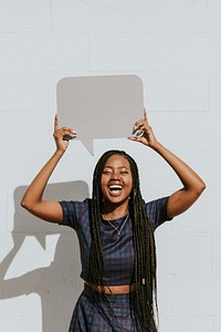 Cheerful black woman showing a blank speech bubble