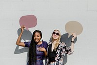 Cheerful women showing blank speech bubbles