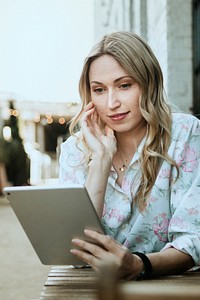 Woman using a digital tablet outdoors