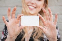 Cheerful white woman showing her business card