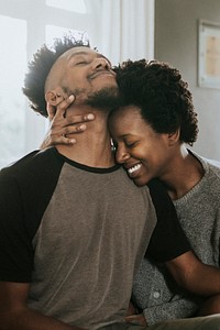 African couple chilling in a living room at home