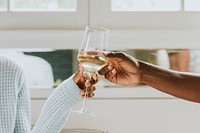 Black couple passing a white glass of wine