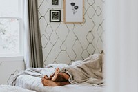 Black couple with their feet under the blanket