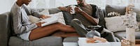 Black couple reading a book together on the couch