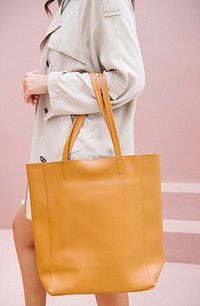 Woman carrying a brown handbag