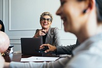 Happy senior woman in a business meeting