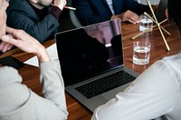 Business people using a laptop in a meeting