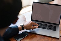 Businessman working on a laptop in a board meeting