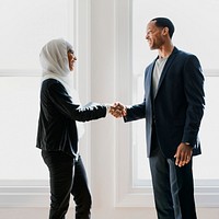 Happy diverse business people shaking hands at the office