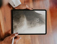 Business person using a wireless stylus with a digital tablet in a meeting