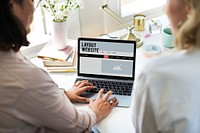 Woman using a laptop in a business meeting