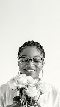 Happy black woman holding a bouquet of flowers