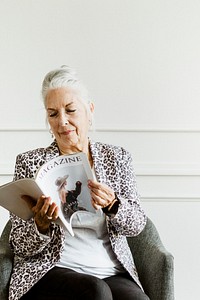 Old woman reading a magazine