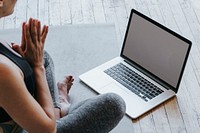 Active woman learning yoga online via a laptop