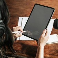 Woman writing on a digital tablet mobile phone wallpaper